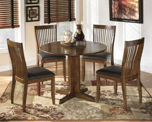 Load image into Gallery viewer, Stuman - Medium Brown - 5 Pc. - Round Drop Leaf Table, 4 Upholstered Side Chairs
